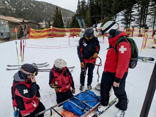 Patrollers gathered around a rescue toboggan