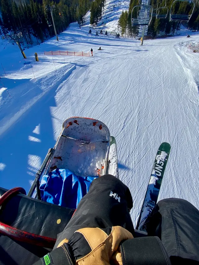 Skis beside a rescue toboggan in the snow
