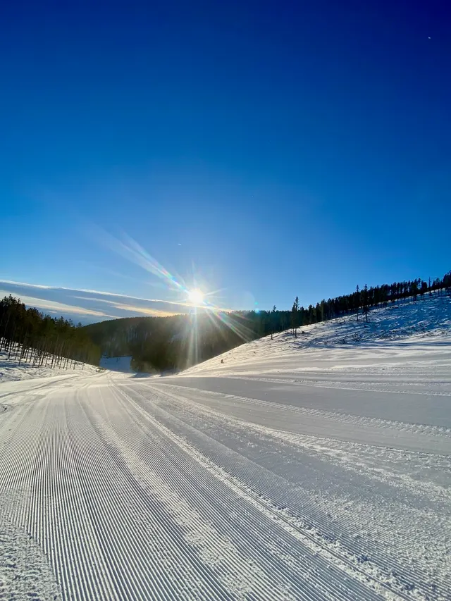 Low sun over a snow-covered run