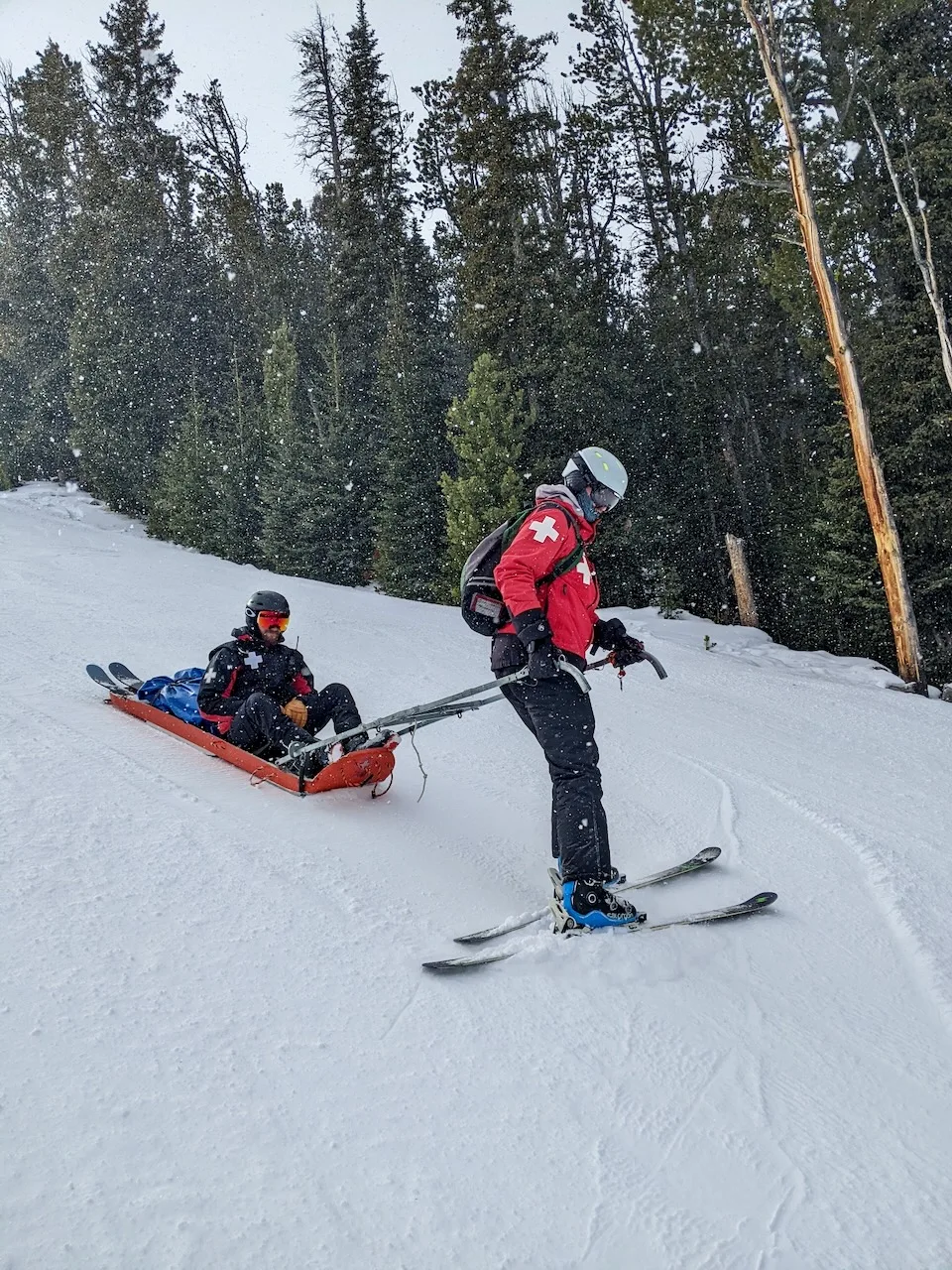 Patroller transporting a rescue toboggan