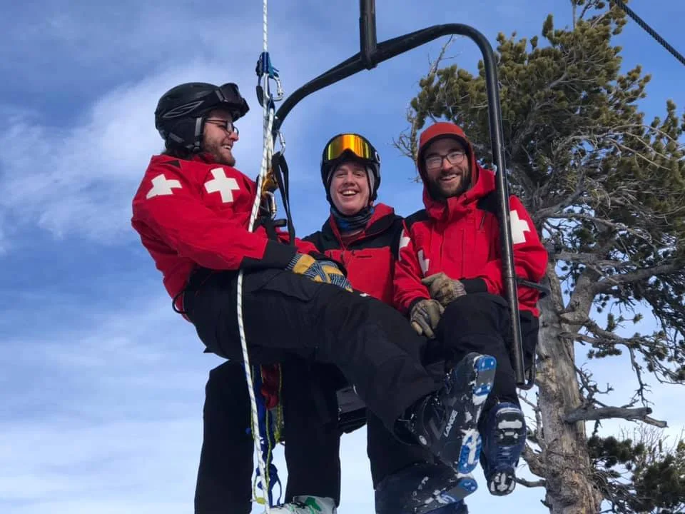 Three patrollers on the mountain