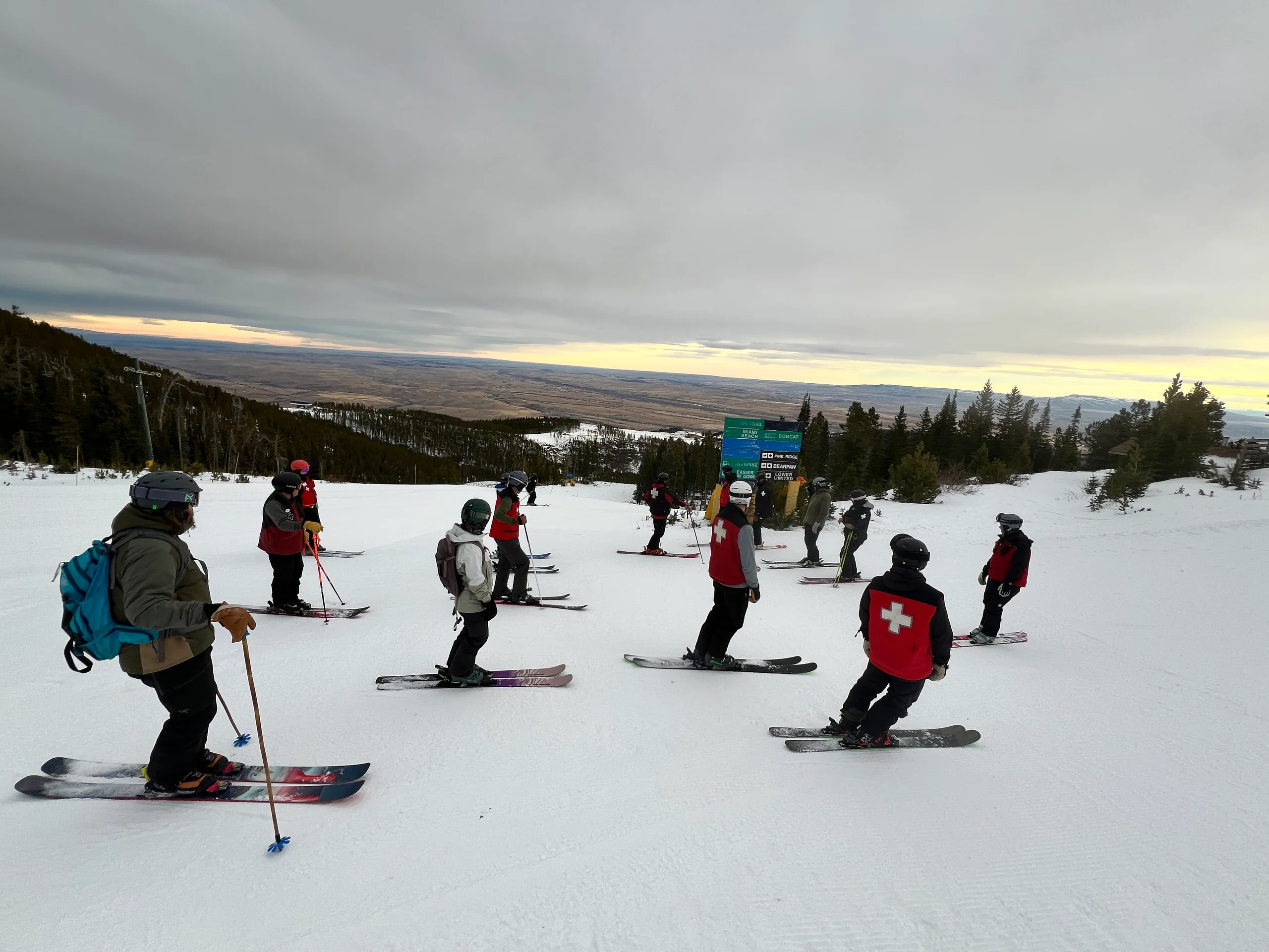 Patrollers gathered on a mountain run