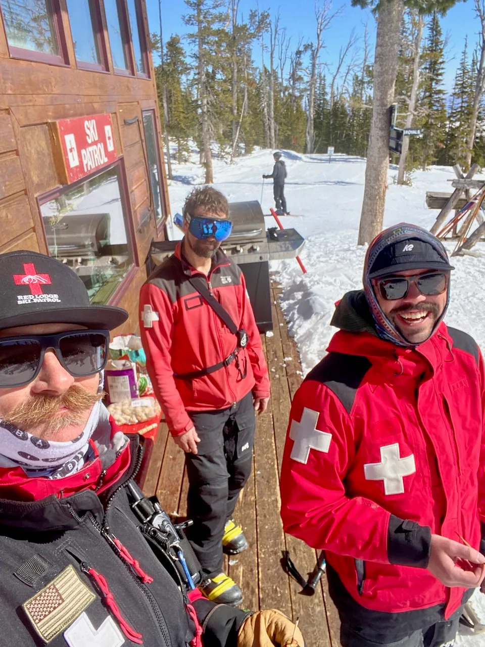 Patrollers together beside a chairlift